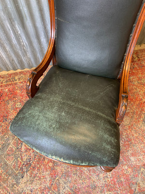 A deep open armchair raised on castors