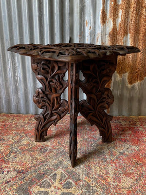 A profusely carved Anglo-Indian table by Jubbar Khan & Son