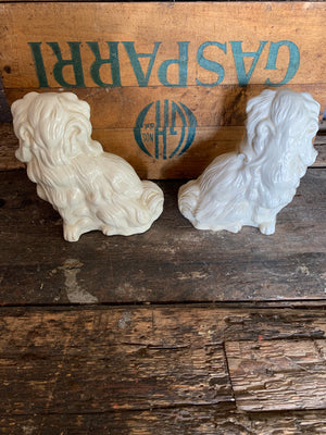 A pair of white ceramic Staffordshire style dogs