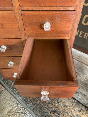 A bank of 12 apothecary drawers