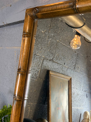 A tall and slim faux bamboo mirror