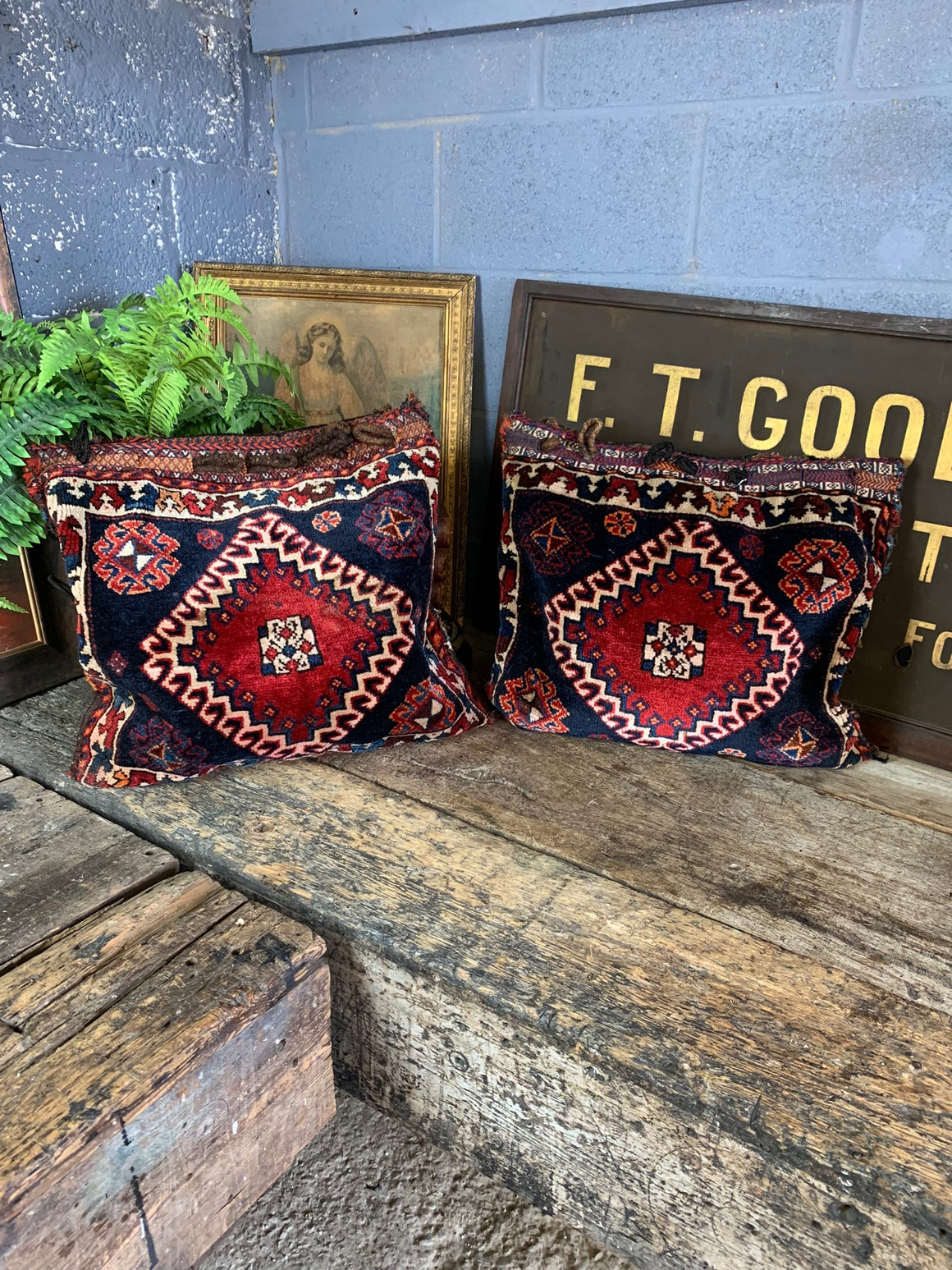 A pair of Persian carpet cushions