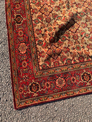 A large red ground velvet throw or 'Dutch tablecloth'