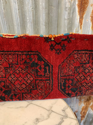 A very large red ground Persian carpet cushion