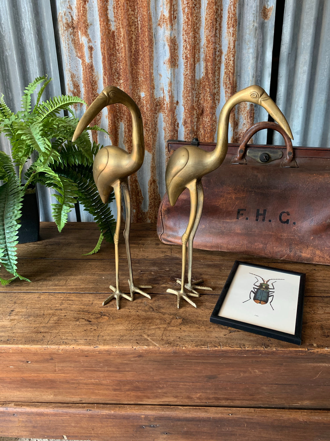 A pair of large brass Mid-Century Hollywood Regency crane statues