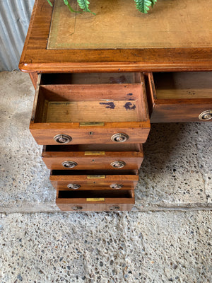 A Victorian tan leather pedestal desk on castors