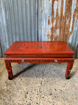 A red lacquer chinoiserie coffee table