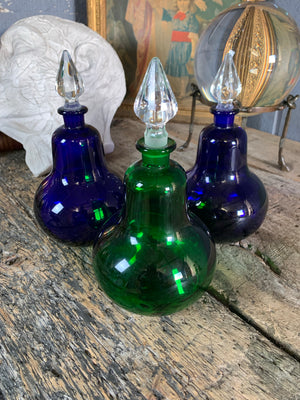 A trio of coloured glass apothecary jars