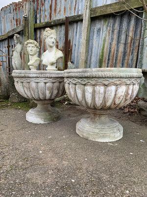 A pair of large cast stone urns