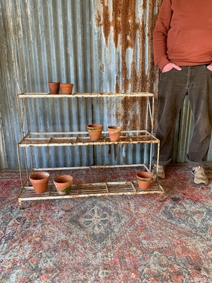 A white cast iron plant stand