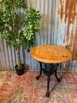 A cast iron Britannia garden table with oak top