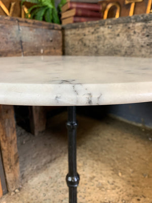 A black cast iron bistro table with marble top 2/3