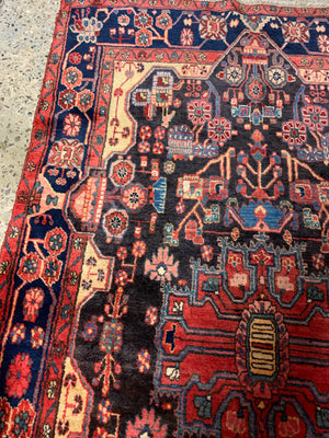 A very large rectangular red ground Persian rug