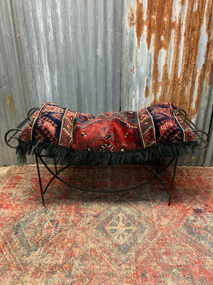 A large rectangular Persian carpet floor cushion