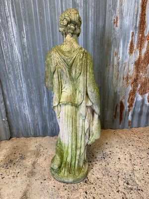 A large cast stone statue of a Grecian woman