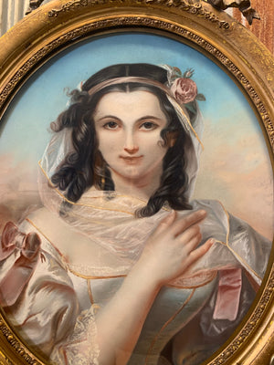 An early 19th Century chalk portrait of a lady in an ornate oval frame