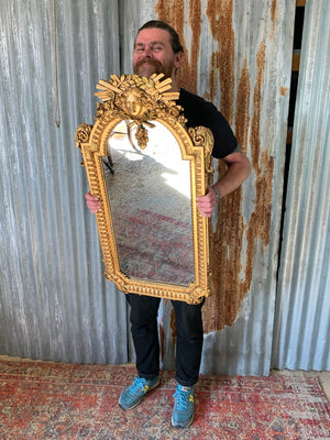 A ‘maiden head’ Louis XIV style gilded mirror