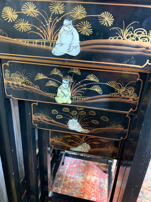 A nest of four black lacquered Chinoiserie tables