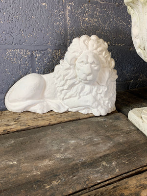 An opposing pair of cast stone flat back lions