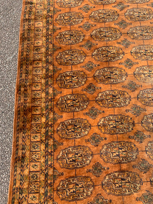 A very large gold ground Bokhara rug