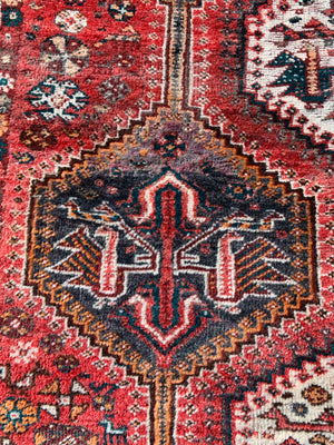 A large red ground Persian rectangular rug- 237cm x 158cm