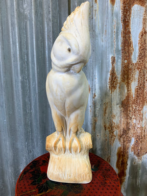 A large white plaster cockatoo statue