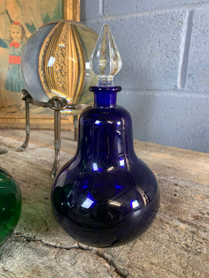 A trio of coloured glass apothecary jars