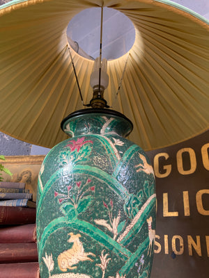 An Oriental green ceramic lamp on a hardwood stand