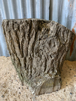 A pair of cast stone faux bois planters