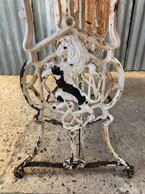 A cast iron garden table with marble top