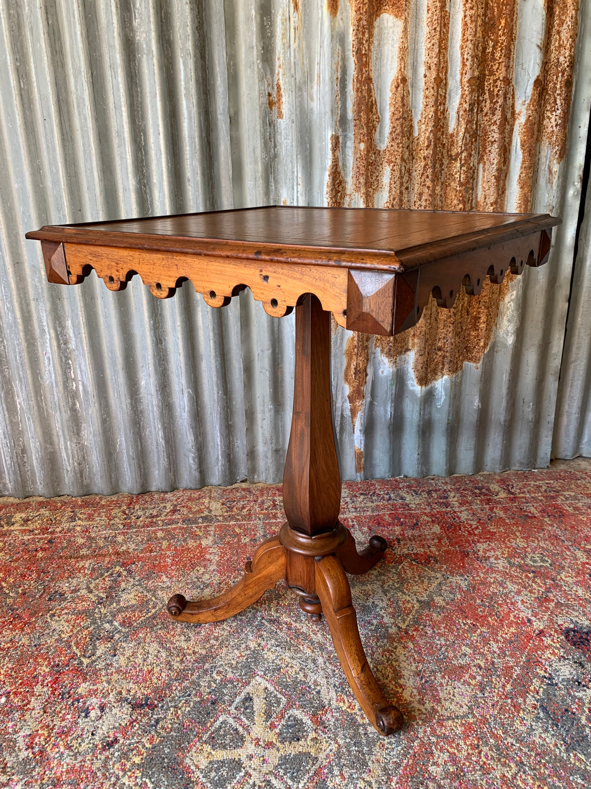 A leather-topped square occasional table