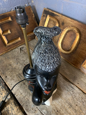 A black African woman figural table lamp