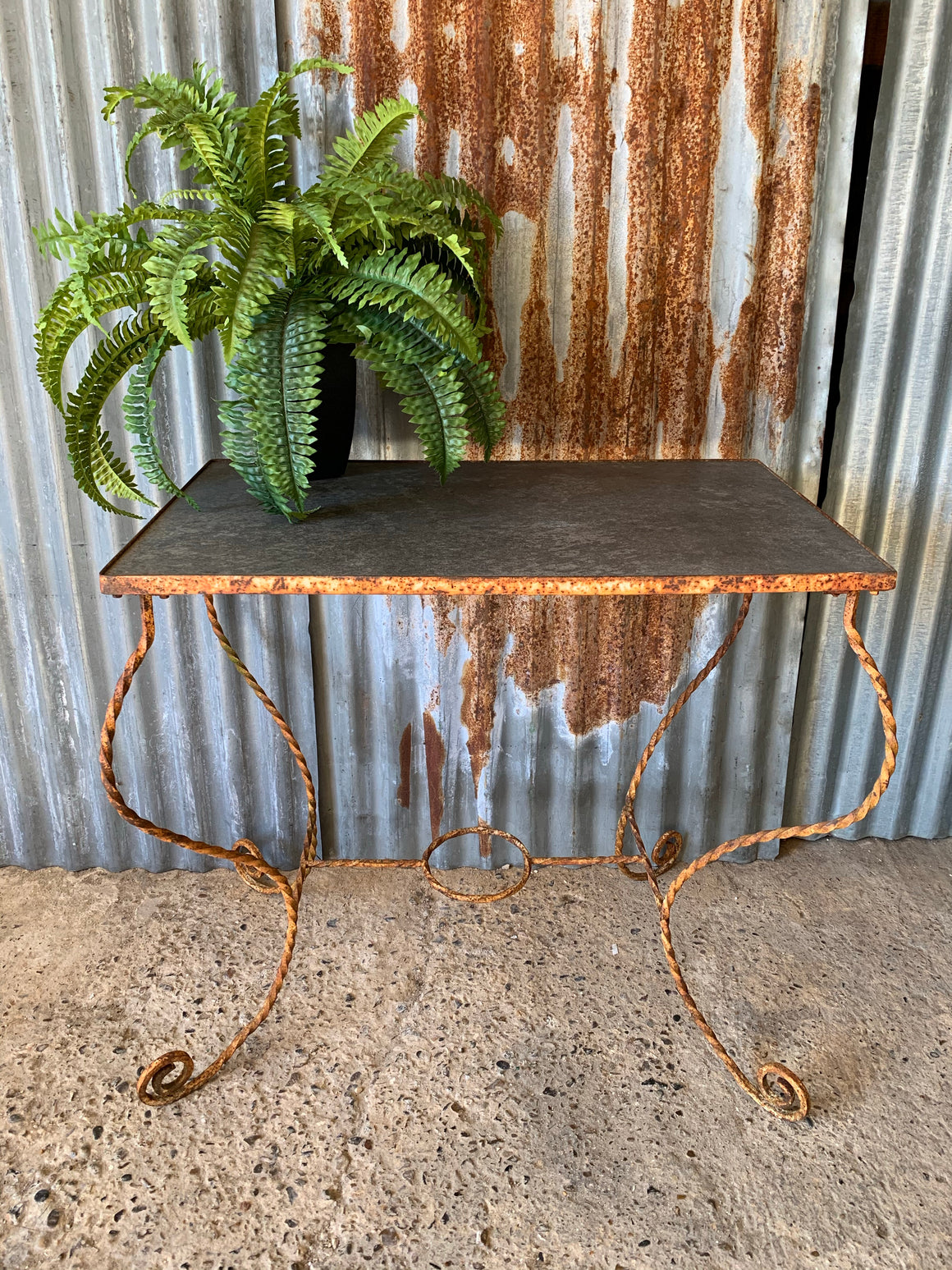 A twisted wrought iron garden table