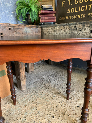 A Victorian single drawer table with ebonised top and glass handles