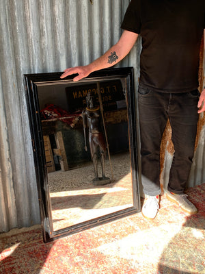 A large rectangular ebonised mirror