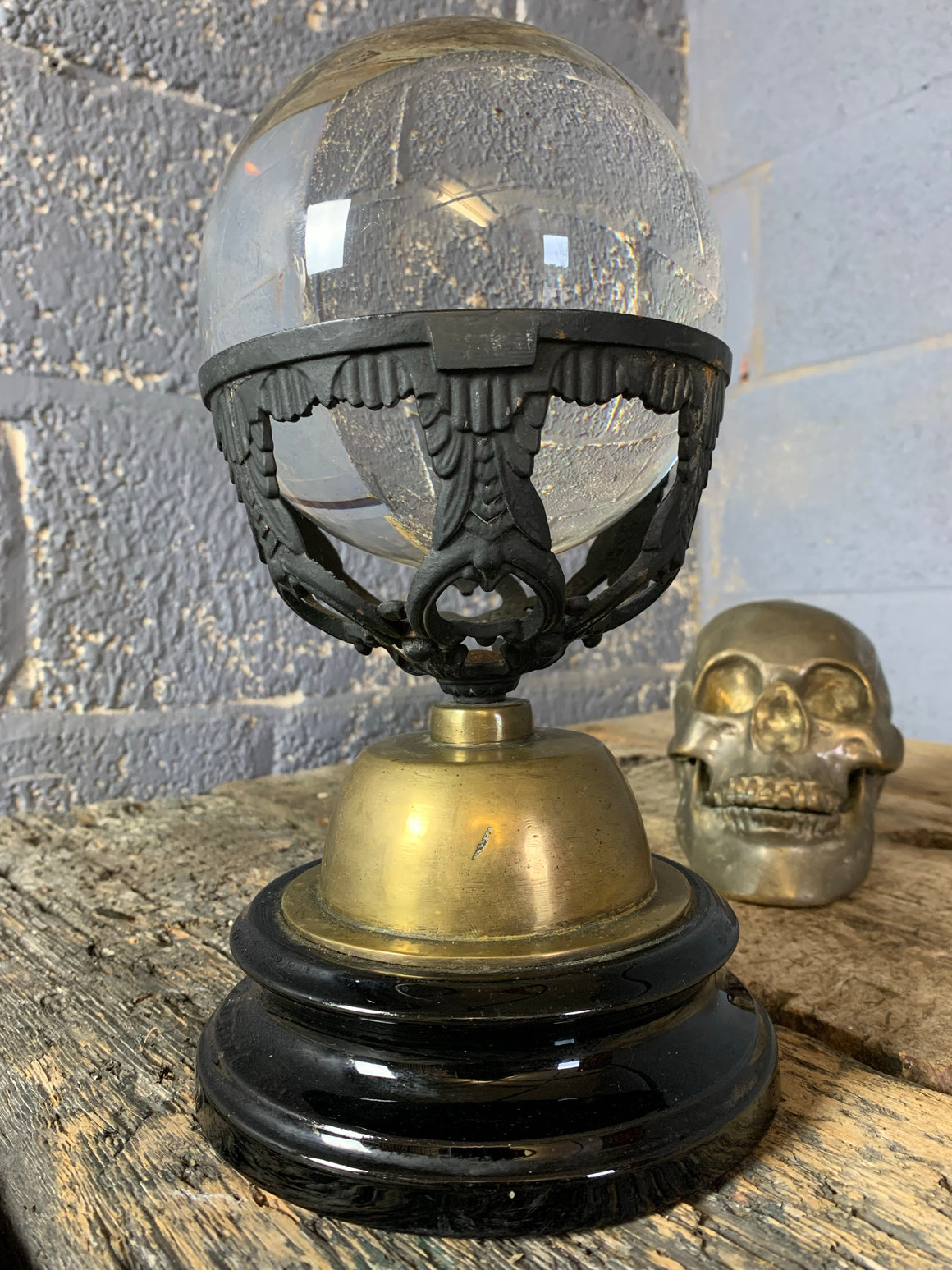 A fortune teller's crystal ball on a black and gold stand