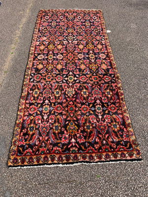 A large red ground Persian runner - 277cm x 116cm