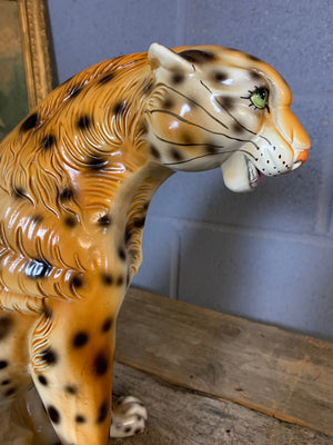 A large ceramic seated leopard statue