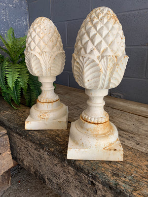 A pair of white cast iron acorn or pineapple finials