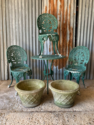 A green garden table and chairs set