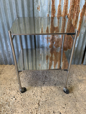 A stainless steel two-tier medical trolley