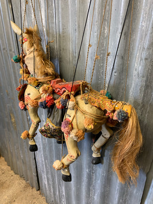 A large carved wooden horse puppet