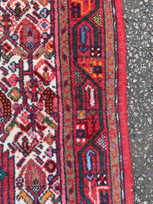 A red ground Persian runner- 217cm x 79cm