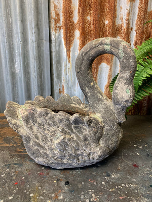 A large terracotta swan planter