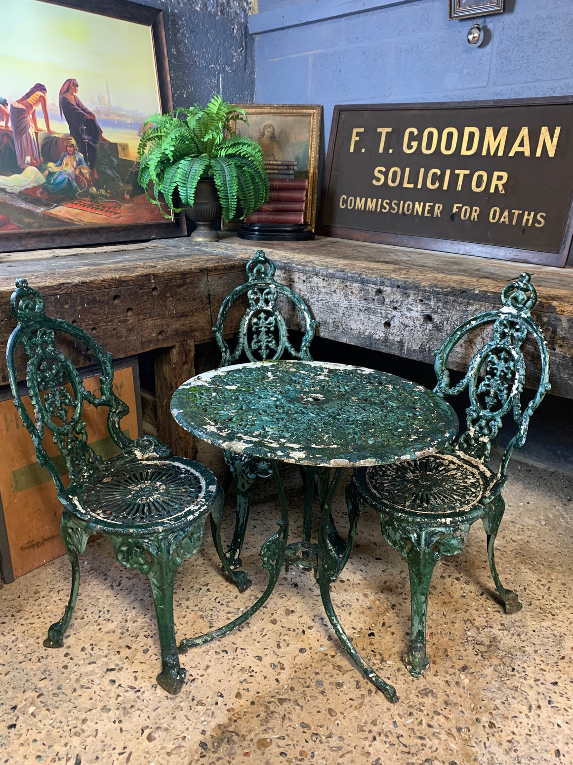 A green garden table and chairs set