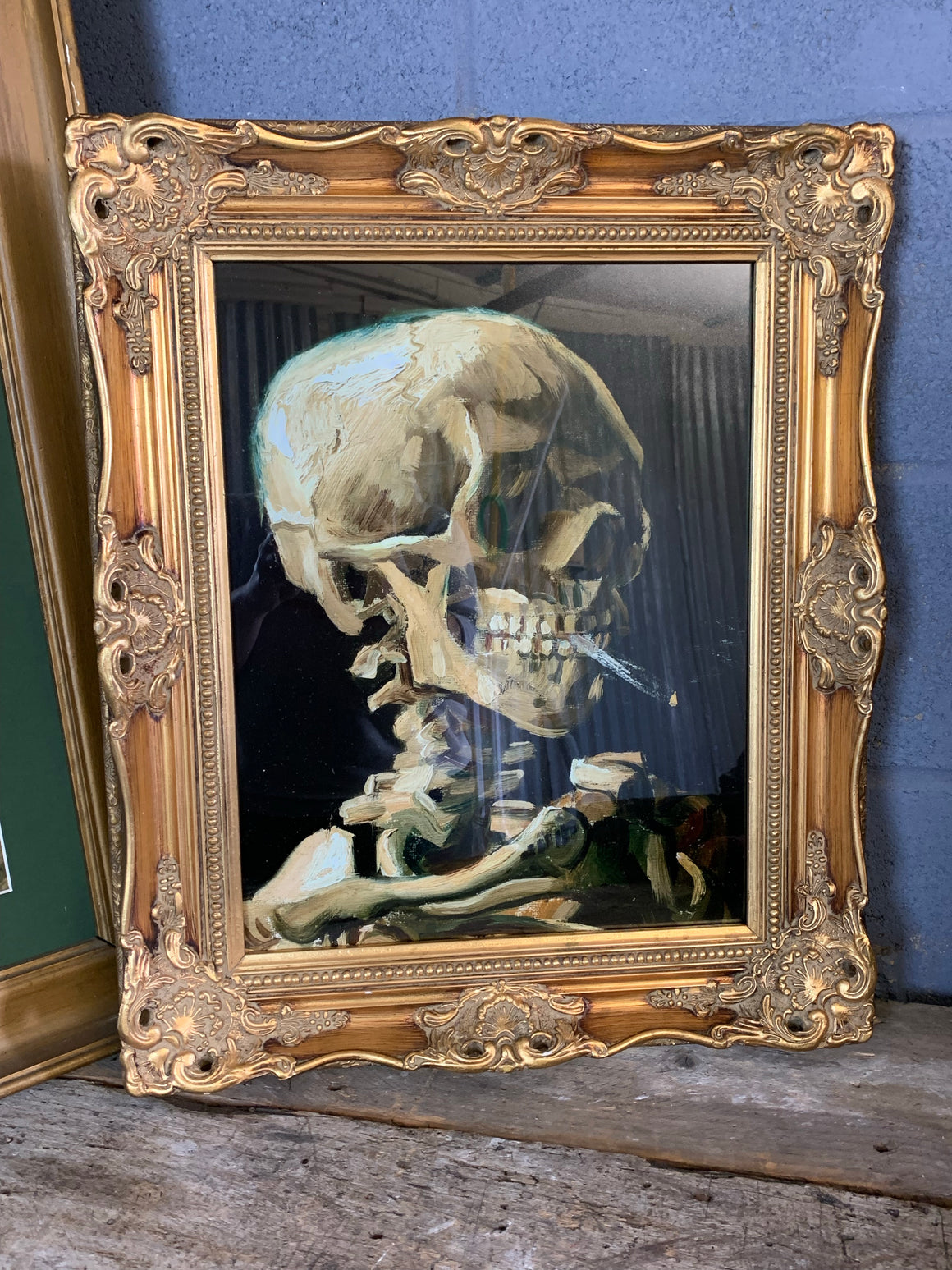 A framed and glazed print of Van Gogh's "Smoking Skeleton" (1885)