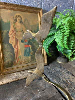 A trio of gilded bronze flocks of birds in flight