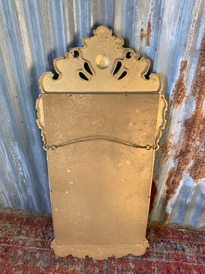 A large Rococo style cast iron mirror