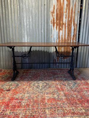 A Victorian cast iron refectory table with wooden top by Thomas Green and Son