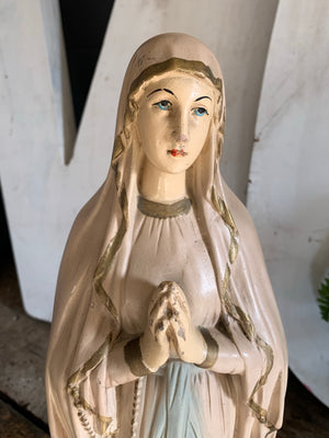 A large plaster Our Lady of Lourdes statue